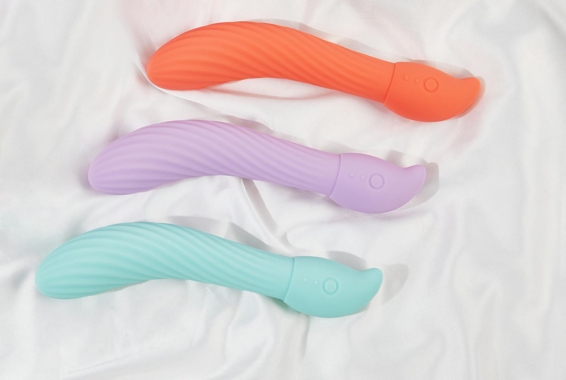 Colorful arrangement of vibrators on a bright background, symbolizing self-care and sexual wellness during medication transitions