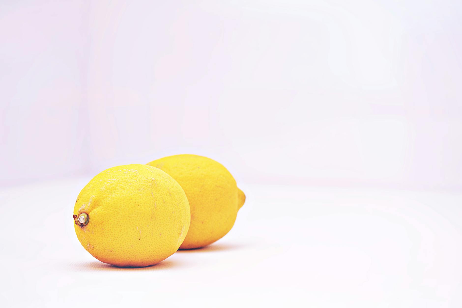 Two bright lemons on a white background symbolizing freshness and new beginnings