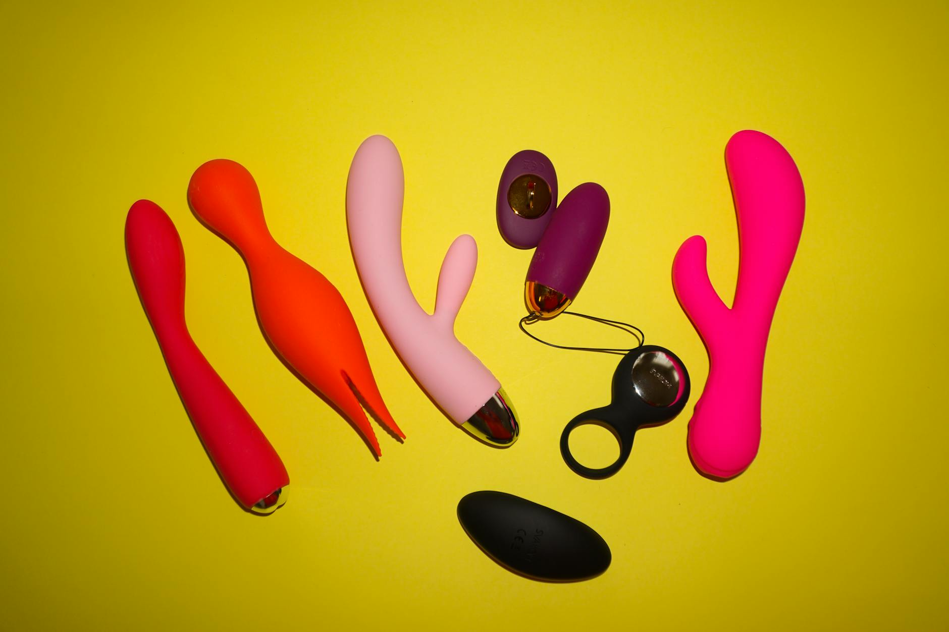 Close-up of a hand holding a vibrator against a purple backdrop, representing reconnection with body and sensation.
